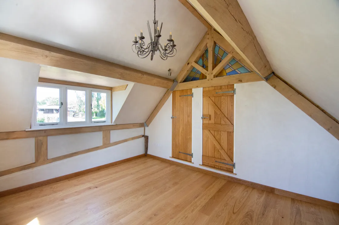 Beautifully finished interior lime plaster showing exposed beam detail