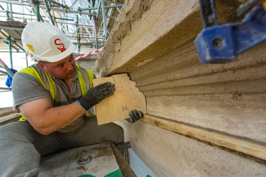Lime green render being used by an expert craftsman